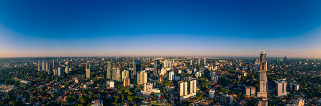 Aerial view of World Trade Center Asuncion and the surrounding modern skyline with lush green trees and urban residential areas Asuncion, Asuncion, Paraguay.