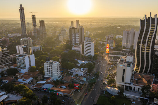 Aerial view of the modern skyline of Asuncion featuring the Banco GNB building surrounded by urban streets and lush trees in Asuncion, Asuncion, Paraguay.