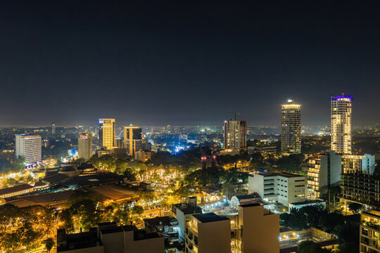 Aerial view of the Las Lomas district in Asuncion at night, featuring illuminated skyscrapers, modern office buildings, and glowing city streets in Asuncion, Asuncion, Paraguay.