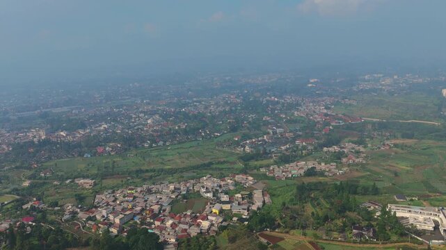Wide Aerial View of Sprawling City in Valley with Mountains
