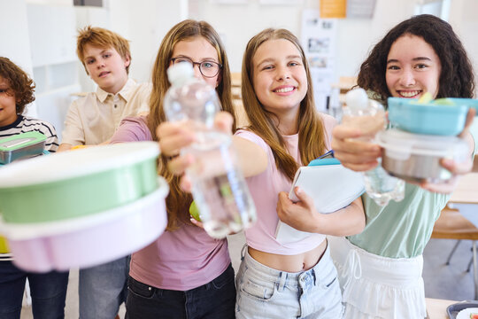 Group of students enjoying healthy food and drinks in a lively cafeteria