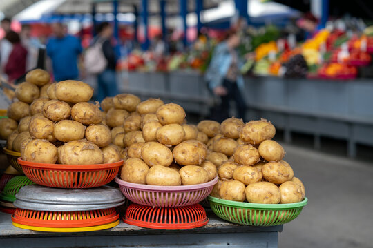 Baskets of potatoes on a stand at a farmers' market or bazaar. Potatoes displayed for sale, grocery store.