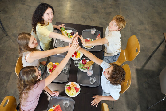 Group of children enjoying lunch together in a school cafeteria