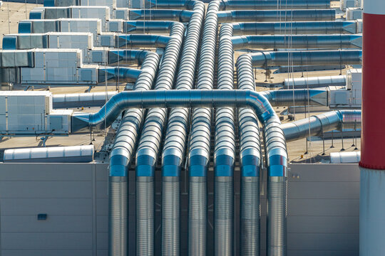 Aerial view of a modern motor boat production facility featuring rows of metallic ventilation ducts on the rooftop in Elk, Warmian-Masurian Voivodeship, Poland.