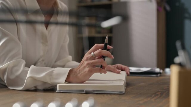 Middle aged Caucasian female therapist talking and writing notes in notebook during counseling session. Footage is perfect for mental health clinics, therapy services, and counseling promos