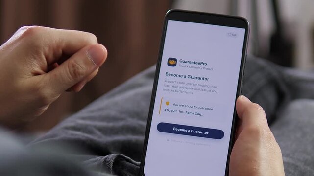 Smartphone displays a legally binding loan guarantee, exploring trust, debt obligations, financial risk and the rapid shift toward paperless banking services.