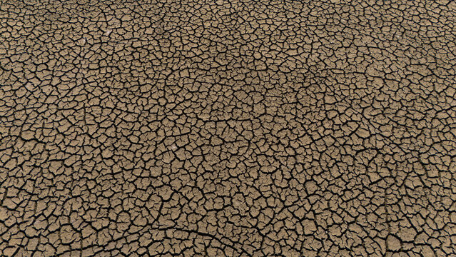 Aerial view of the dry and cracked earth of the drought-stricken lake bed in Cavuscugol, Konya, Turkiye.