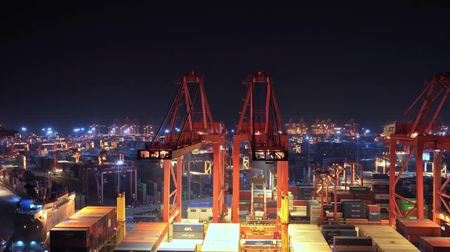 Unloading large cargo containers seaport. Loading freight sea port. Top aerial drone view. Lot big boxes rows, ship delivery ocean harbor. Shipping night. Goods export import. Industrial Marine dock.
