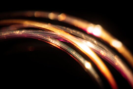 Warm rainbow light leaks on a black background with defocused crystal arcs for vintage film overlay