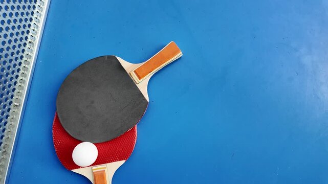Table tennis paddles and ball on ping pong table
