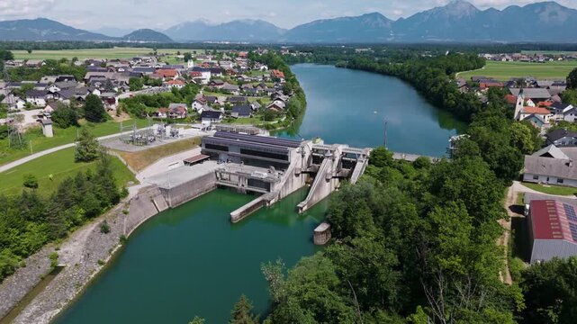 A hydropower plant is generating electricity using water and solar panels on its roof. This facility produces renewable energy.