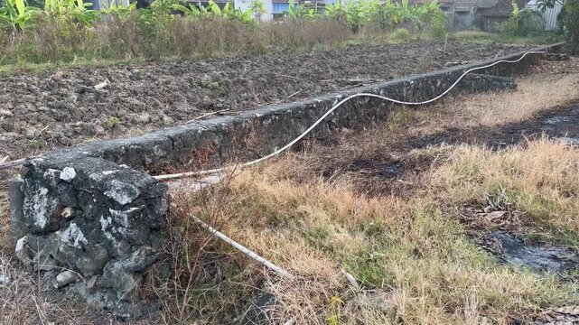 Traditional Stone House Foundation Next to Rural Farmland