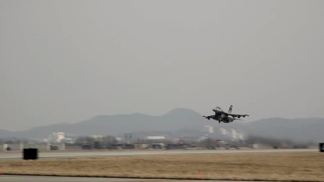 F-16 Fighting Falcon Taking Off from Military Airbase Runway During Training Mission