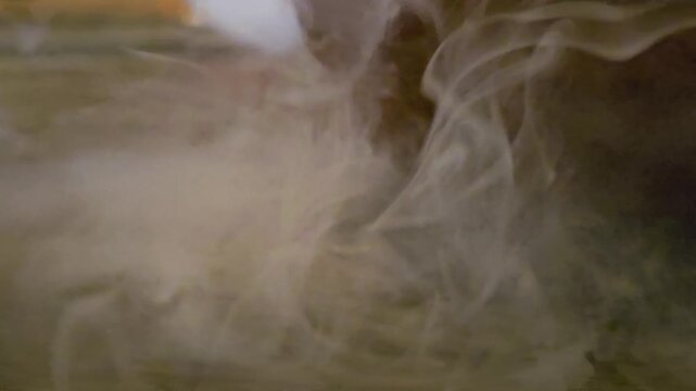 Milky white vapor or ink spreading through dark liquid, creating delicate wisps, cloudy turbulence, and abstract slow motion texture for cinematic backgrounds, overlays, or transitions.