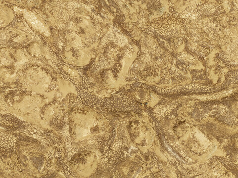 Aerial view of the rugged desert landscape of the Skeleton Coast with intricate sand patterns and dry riverbeds in Kunene Region, Namibia.