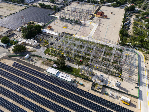 Aerial view of the solar and power plant featuring rows of photovoltaic panels and electrical infrastructure in Merida, Yucatan, Mexico.