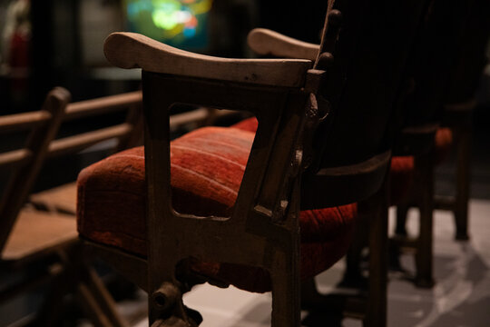 Vintage Wooden Chairs Row In Dimly Lit Theater