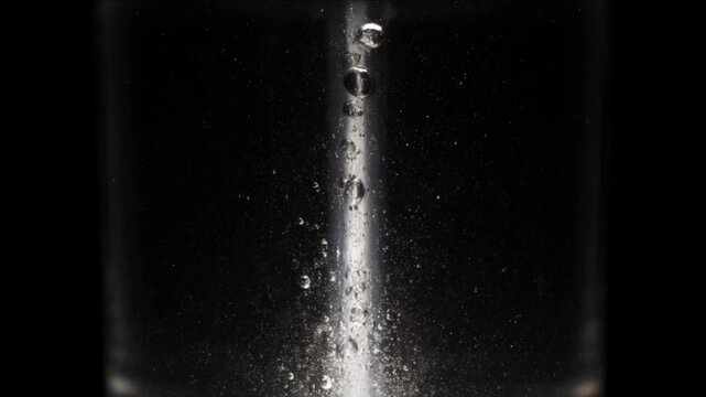 Sparkling bubble column ice water background texture minimal dark black macro abstract vertical stream motion chill splash effect clean liquid purity refresh energy motion detail concept