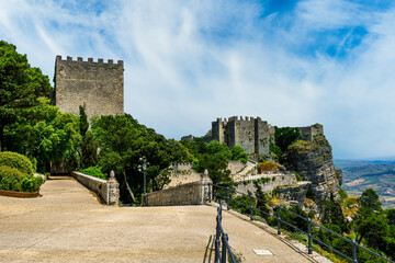 scenic view of panoramic landscape of beautiful italian town Erice in Sicily with old mediewal castle and wall of antique tower and blue day cloudy sky on background © Yaroslav