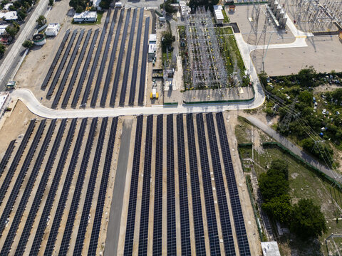 Aerial view of the solar and power plant featuring rows of photovoltaic panels and an electrical substation in Merida, Yucatan, Mexico.