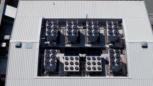 Aerial view of industrial data center ventilation and cooling fans installed on a metal roof in Redditch, England, United Kingdom.