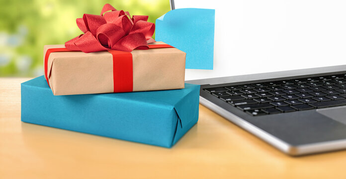 Online Shopping Gifts Beside Laptop With Copyspace