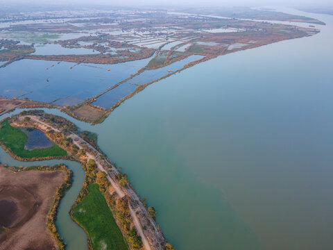 Aerial view of Qadirabad Head Works Bridge spanning the Chenab River, surrounded by agricultural fields, irrigation channels, and calm water in Wazirabad, Punjab, Pakistan.