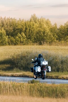Peaceful evening motorcycle ride through green fields