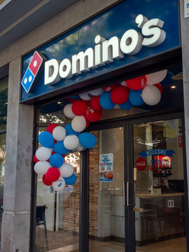 dominos pizza restaurant entrance decorated with red white blue balloons