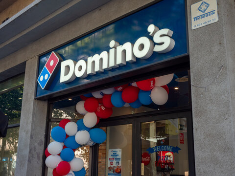 dominos pizza restaurant entrance decorated with red white blue balloons