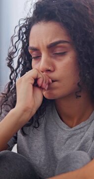 Woman, thinking or stress in home with biting nails, bad habit or nervous tension in living room. Mental health, stimming or person with depression, compulsive behavior or coping mechanism in lounge