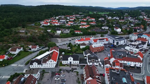 Aerial view of white wooden houses with red roofs in the coastal town of Lillesand, Agder, Norway.