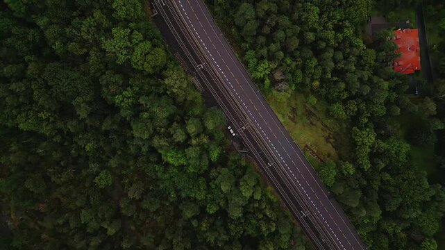 Aerial view of Ekebergparken railway cutting through the dense forest landscape in Oslo, Oslo, Norway.