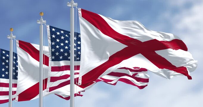 Alabama and the United States flags waving on a sunny day