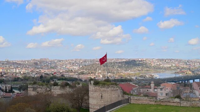 Turkish flag waving over the Walls of Constantinople and Istanbul cityscape