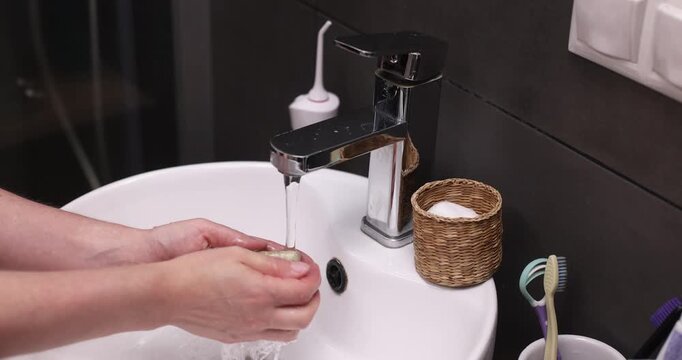 Woman washing hands under faucet, hygiene, cleanliness