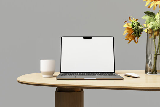 Laptop mockup on wooden desk with coffee cup and vase of flowers, workspace scene.