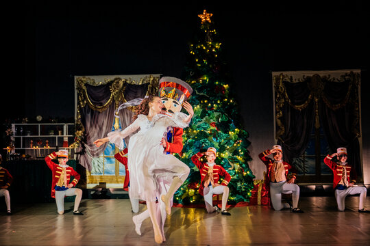 Ballerina dances with wooden soldier on stage