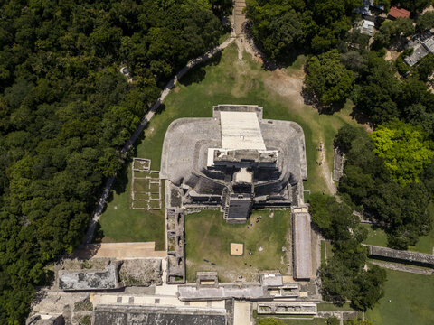 Aerial view of the Pyramid of the Magician at the ancient Maya city of Uxmal, surrounded by lush jungle vegetation and historic stone ruins in Uxmal, Yucatan, Mexico.