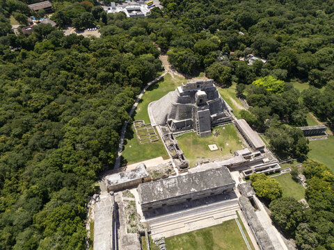 Aerial view of the ancient Mayan Pyramid of the Magician at the Uxmal archaeological site surrounded by lush jungle vegetation in Uxmal, Yucatan, Mexico.