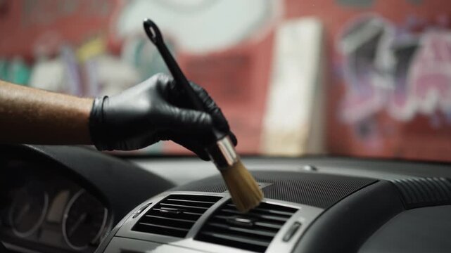 Professional automotive technician performing interior detailing as part of routine vehicle maintenance, help preserve appearance, cleanliness and long term value of modern automobile