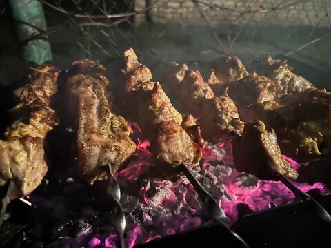 Pork grilled over coals in the evening heat