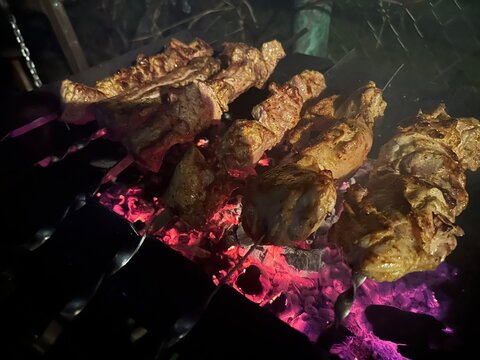 Pork grilled over coals in the evening heat