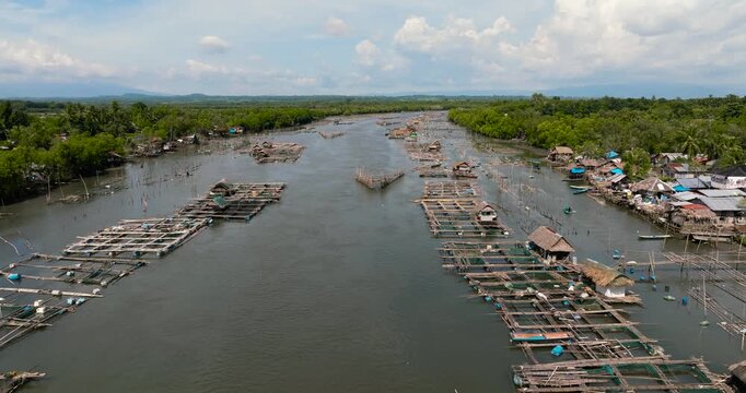 Top view of fish farm with cages and nets on the river. fishing village. Hinigaran River. Negros, Philippines
