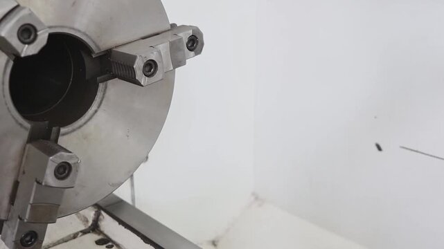 Close-up of a lathe with a chuck and a steady rest in a training workshop. Metalworking, mechanical engineering and vocational education.