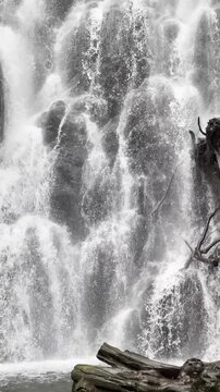 Vertical shot of rapid waterfall stream background.