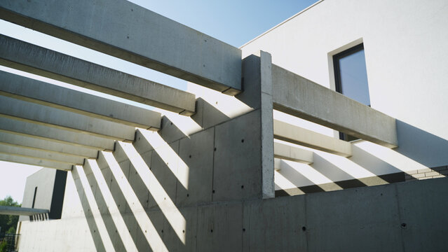 Modernist concrete architecture facade with geometric shadows and minimalist design on a sunny day
