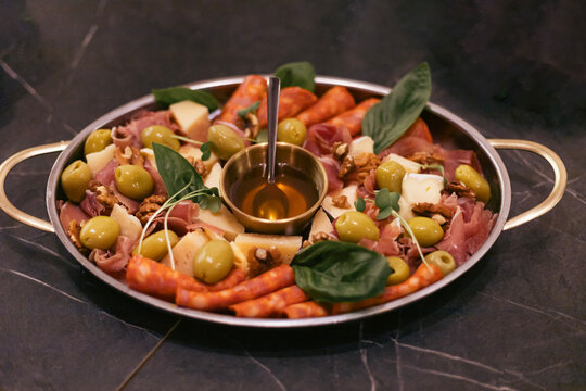 Charcuterie platter with assorted meats cheeses and olives