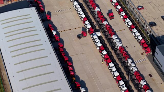 Northampton, United Kingdom - 23 July 2026: Aerial view of the Royal Mail National Distribution Centre featuring rows of parked trucks in the loading yard.