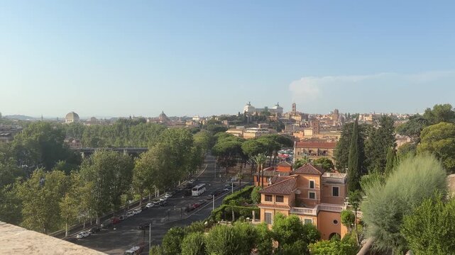Panoramic view of Rome from Giardino degli Aranci, featuring historic rooftops, lush trees, and iconic landmarks under a clear blue sky in the heart of the Eternal City.
